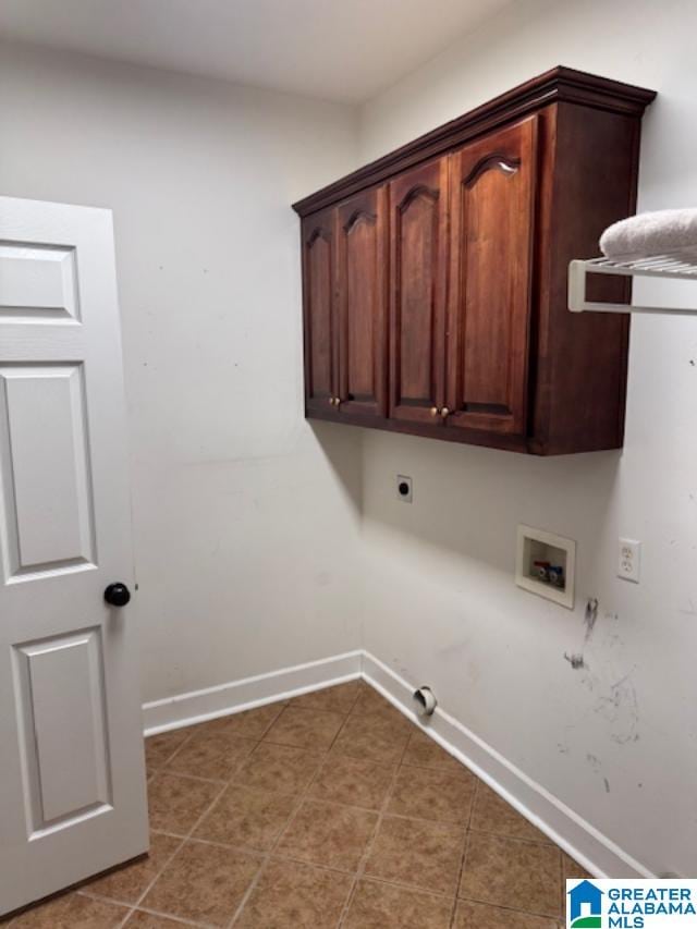 clothes washing area with dark tile patterned floors, cabinets, washer hookup, hookup for a gas dryer, and hookup for an electric dryer