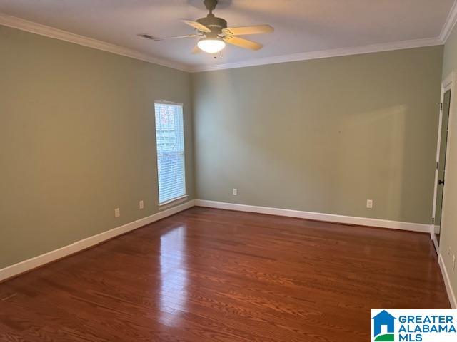 unfurnished room with crown molding, dark hardwood / wood-style floors, and ceiling fan