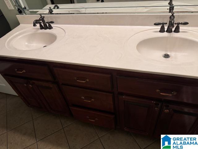 bathroom with tile patterned floors and vanity
