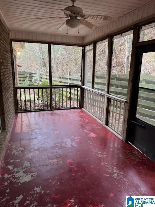 unfurnished sunroom featuring ceiling fan