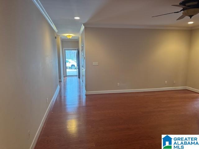 corridor featuring dark hardwood / wood-style flooring and ornamental molding