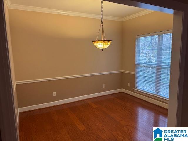 spare room with crown molding and hardwood / wood-style floors
