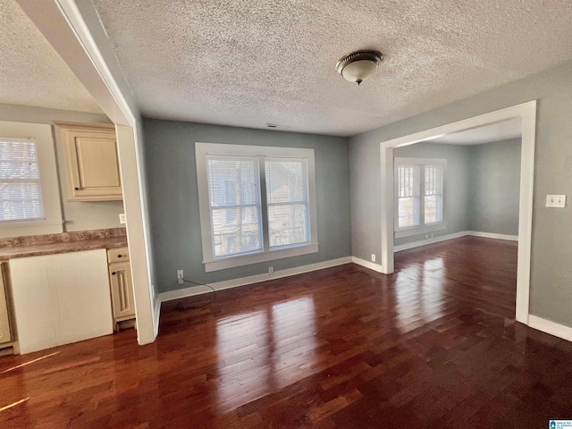 unfurnished dining area with dark wood-type flooring