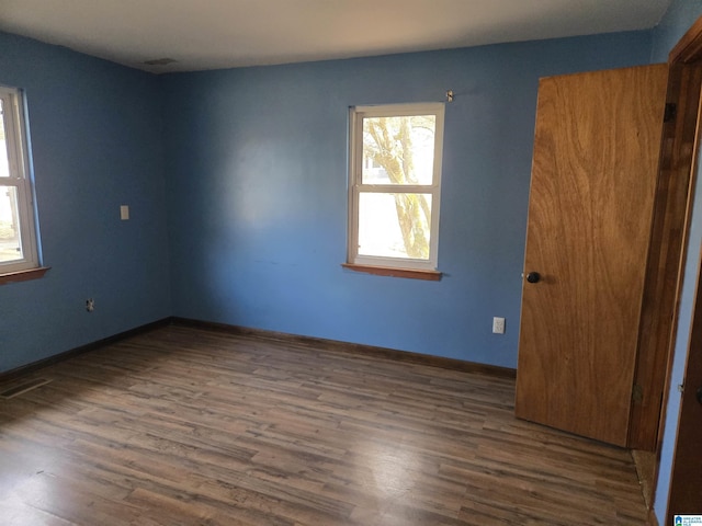 empty room with dark hardwood / wood-style floors