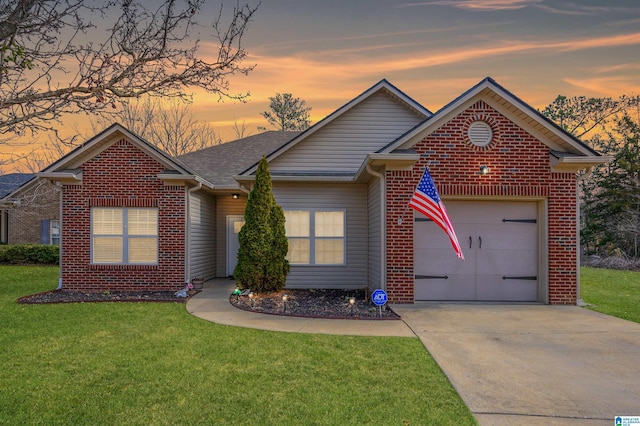 view of front of property with a garage and a lawn