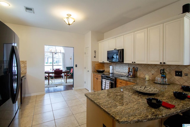 kitchen featuring stone counters, tasteful backsplash, black appliances, white cabinets, and kitchen peninsula