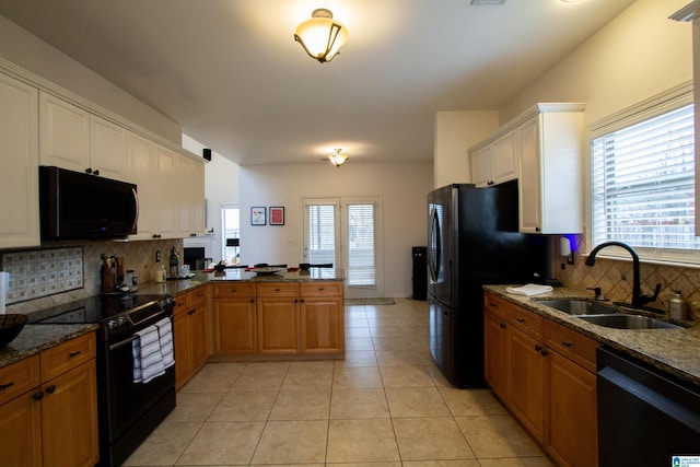 kitchen with sink, light tile patterned floors, black appliances, decorative backsplash, and kitchen peninsula