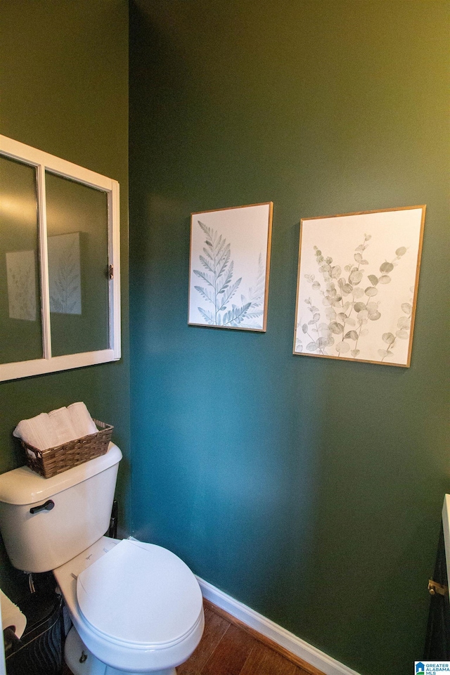 bathroom with hardwood / wood-style flooring and toilet