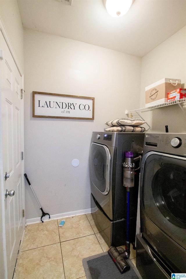 laundry room with light tile patterned floors and washer and dryer