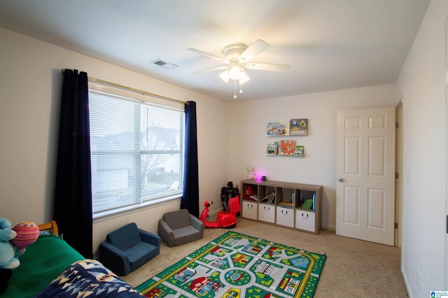 recreation room with ceiling fan and carpet floors