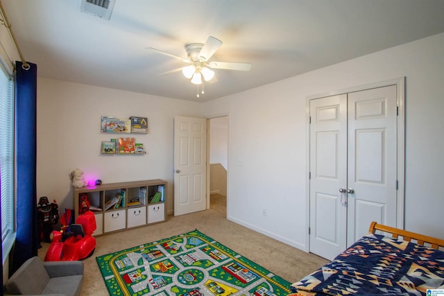 playroom featuring light carpet and ceiling fan