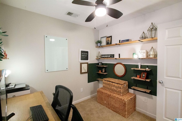 home office featuring light carpet and ceiling fan