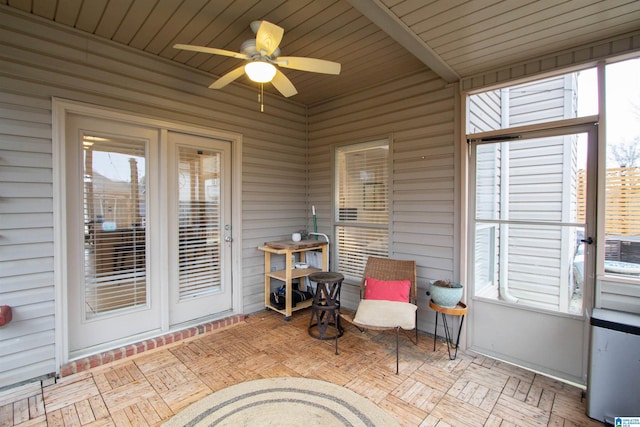 sunroom with ceiling fan and a healthy amount of sunlight