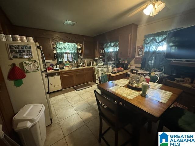 dining room with light tile patterned flooring and ceiling fan