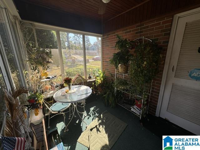 sunroom / solarium featuring wood ceiling