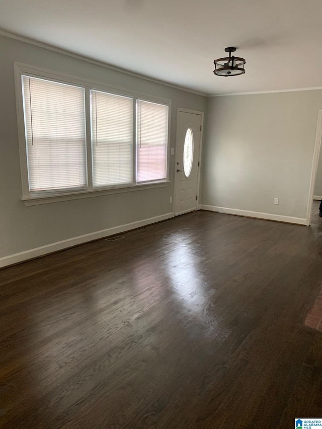 entrance foyer with crown molding and dark hardwood / wood-style flooring