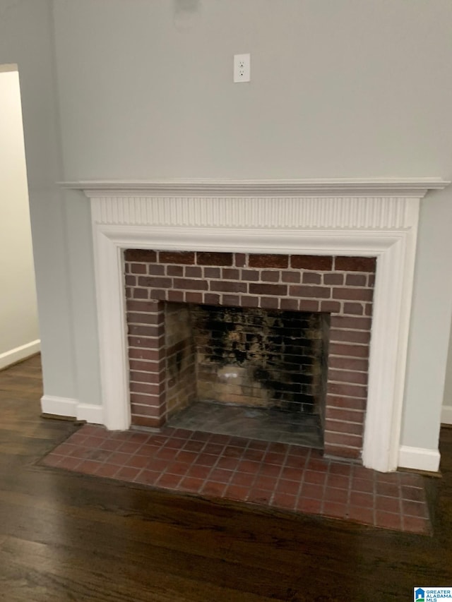 details featuring a tile fireplace and hardwood / wood-style floors