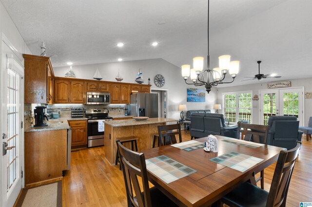 373 Pineywoods Dr, Wedowee, AL 36278 - dining room featuring vaulted ceiling, a chandelier, light hardwood / wood-style floors, and french doors