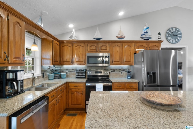 373 Pineywoods Dr, Wedowee, AL 36278 - kitchen featuring tasteful backsplash, sink, vaulted ceiling, and appliances with stainless steel finishes