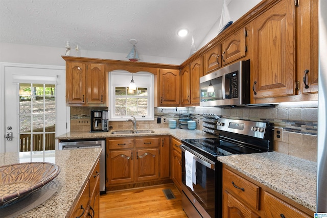 373 Pineywoods Dr, Wedowee, AL 36278 - kitchen featuring light stone counters, appliances with stainless steel finishes, sink, and a wealth of natural light