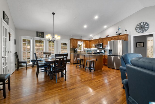 373 Pineywoods Dr, Wedowee, AL 36278 - dining area with a notable chandelier, hardwood / wood-style flooring, and high vaulted ceiling