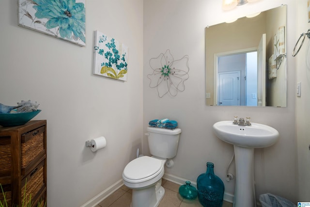 bathroom featuring tile patterned floors, toilet, and sink