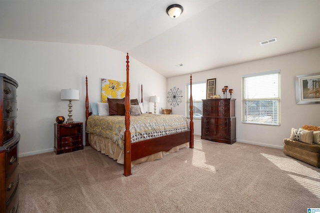 carpeted bedroom with lofted ceiling