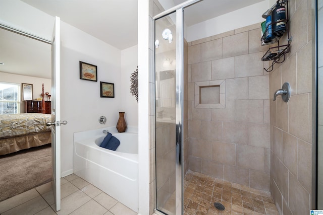 bathroom with tile patterned flooring and shower with separate bathtub