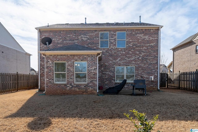 rear view of property featuring a lawn