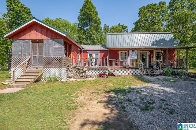 view of front facade featuring a sunroom and a front yard