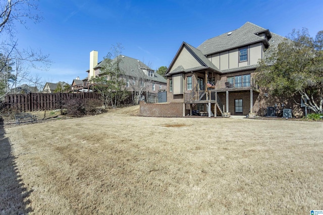 rear view of house featuring a lawn