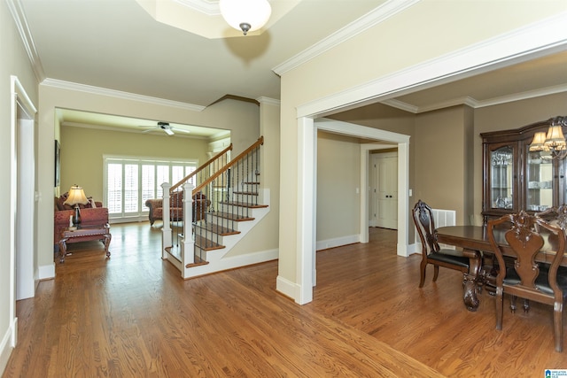 dining space featuring ornamental molding, hardwood / wood-style floors, and ceiling fan