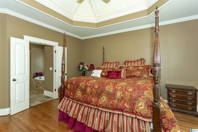 bedroom with a raised ceiling, wood-type flooring, crown molding, and ceiling fan