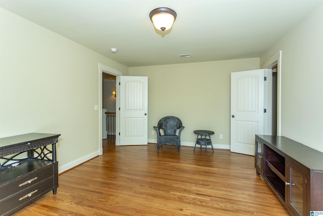 living area with hardwood / wood-style flooring