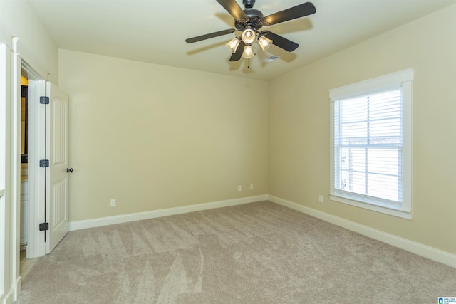 spare room with light carpet and ceiling fan