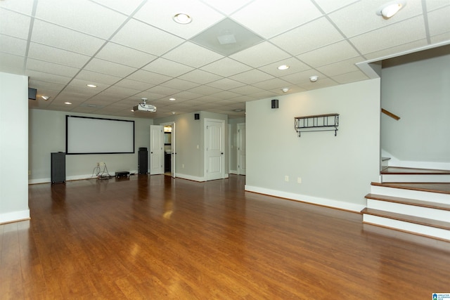 empty room featuring a drop ceiling and dark hardwood / wood-style floors