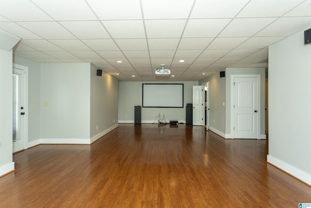 unfurnished room featuring dark hardwood / wood-style flooring and a drop ceiling