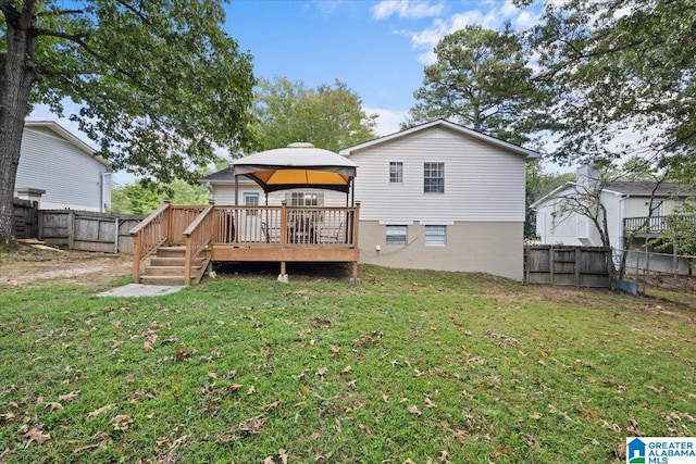 back of house featuring a yard, a gazebo, and a deck