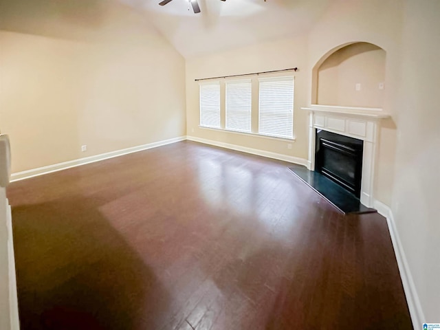 unfurnished living room with dark wood-type flooring, vaulted ceiling, and ceiling fan