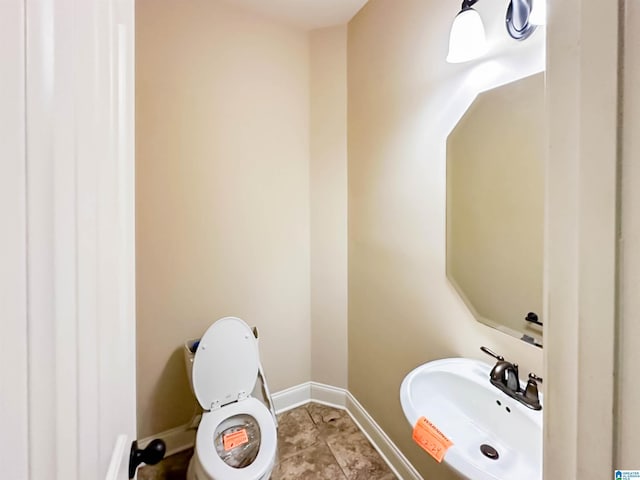 bathroom featuring tile patterned floors, toilet, and sink