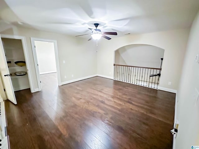 spare room with ceiling fan and dark hardwood / wood-style flooring