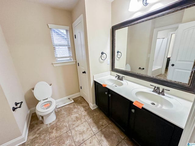 bathroom featuring tile patterned flooring, vanity, and toilet