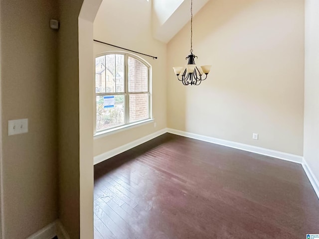 unfurnished dining area featuring high vaulted ceiling, dark hardwood / wood-style floors, and a chandelier