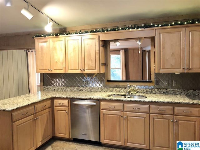 kitchen with dishwasher, sink, backsplash, and light stone counters