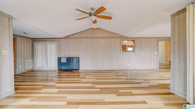 unfurnished living room featuring lofted ceiling, ceiling fan, and light hardwood / wood-style flooring