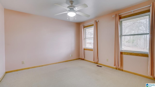 carpeted empty room featuring ceiling fan