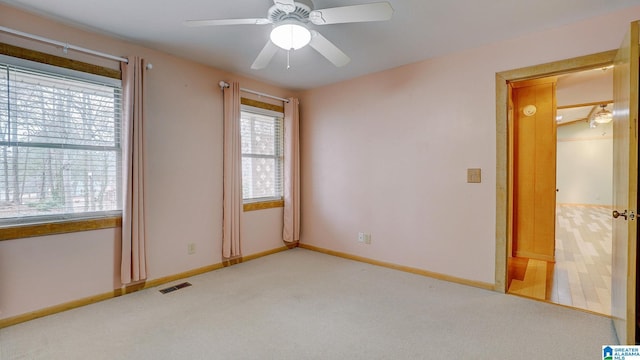 carpeted empty room featuring ceiling fan