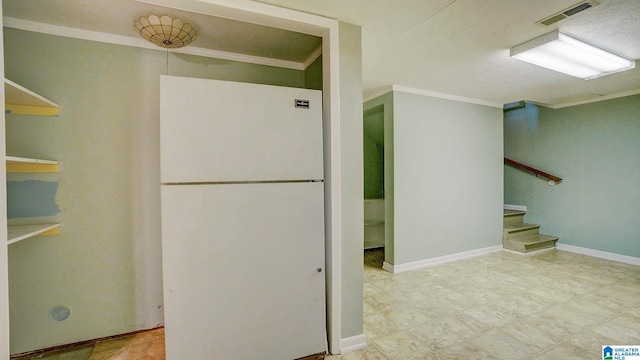 interior space featuring ornamental molding and white fridge