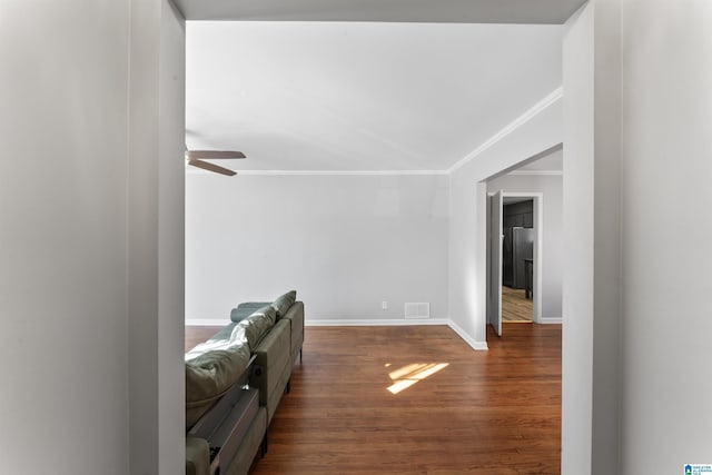 living room with crown molding, dark hardwood / wood-style floors, and ceiling fan