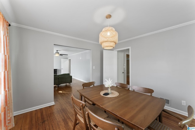 dining space featuring crown molding and dark hardwood / wood-style floors